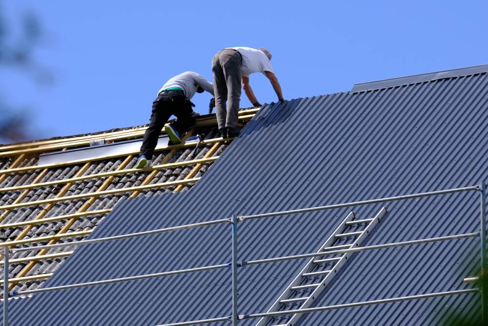 Two,Carpenters,Are,Replacing,Roof,Tiles,In,Norway.