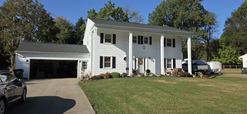 A pure white house of new siding on a sunny day.